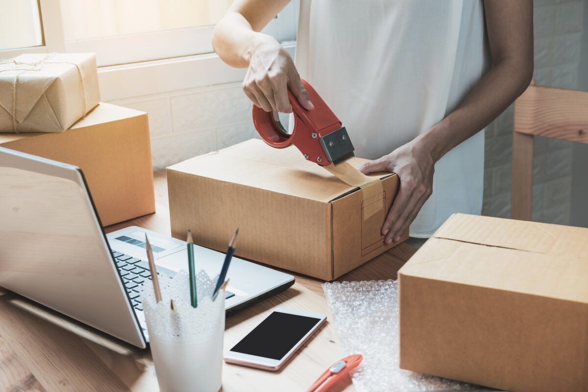 woman taping boxes